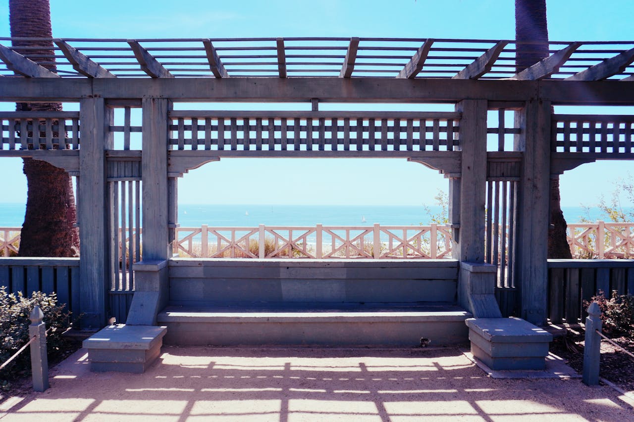 Relaxing coastal view from a wooden pergola in Santa Monica, California.